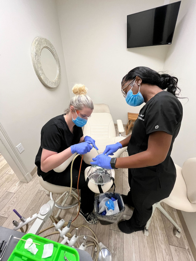 student working with their instructor on dental procedures